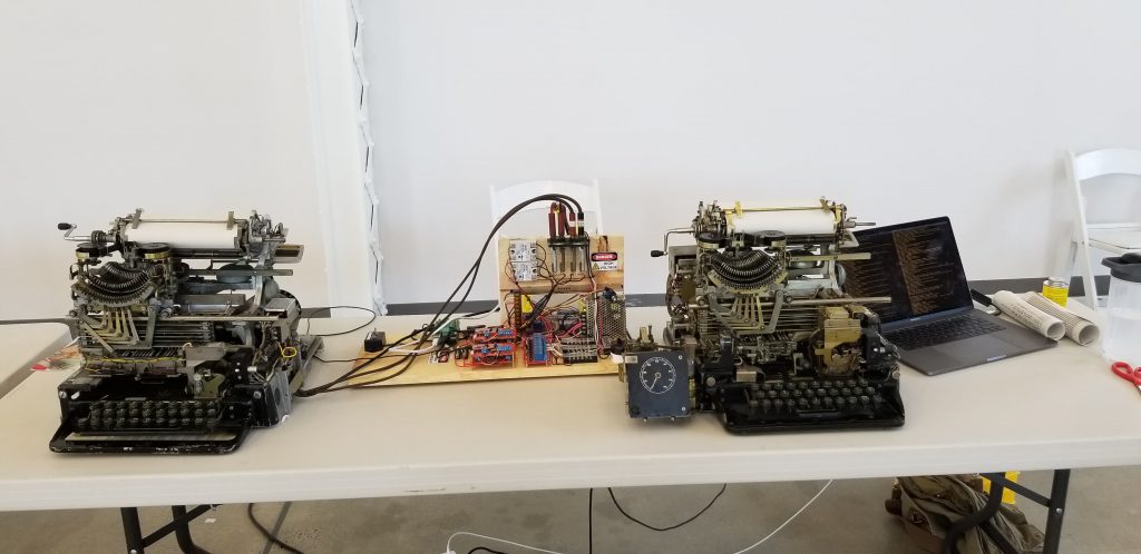 Left: Teletype Model 15 (labeled TG-7-A for U.S. military use). Center: teletype interface/power distributor/controller. Right: Teletype Model 19 (labeled TT-7/FG for U.S. military use).  Far right: 2017 Macbook Pro-- the piece of hardware I hate the most in this array.